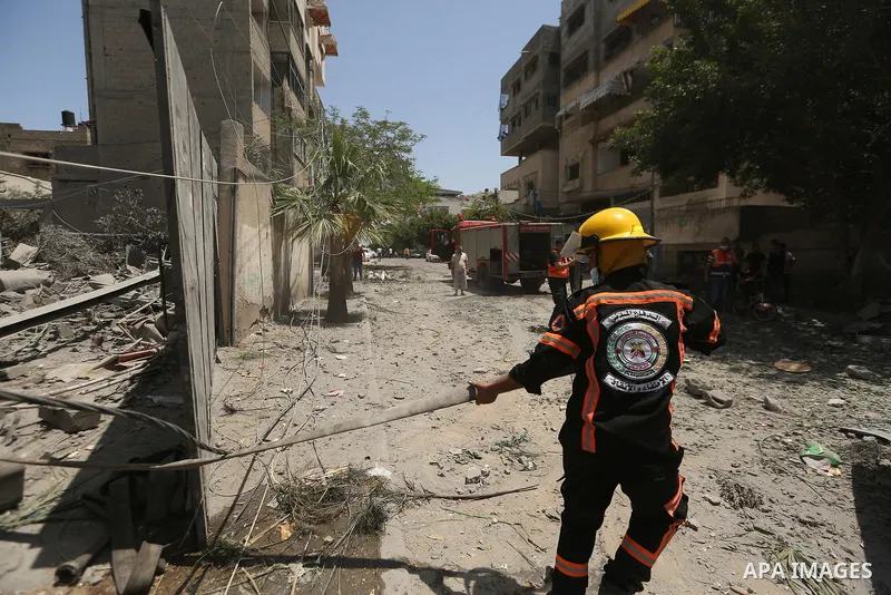 Palestinians inspect building after it is destroyed in an Israeli airstrike in Gaza city on May 16, 2021. Israel's army said it had bombed the home of the political leader of Islamist group Hamas in the Gaza Strip, as th...