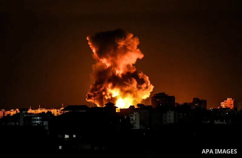 Fire and smoke rise above buildings in Gaza City as Israeli warplanes target the Palestinian enclave, early on May 17, 2021. Deadly violence erupted across the West Bank amid a massive aerial bombardment in Gaza and unpr...