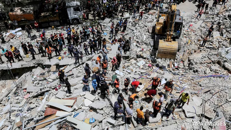 Palestinians search for victims under the rubble of a destroyed building in Gaza City's Rimal residential district following massive Israeli bombardment on the Hamas-controlled enclave on May 16, 2021. Deadly violence er...