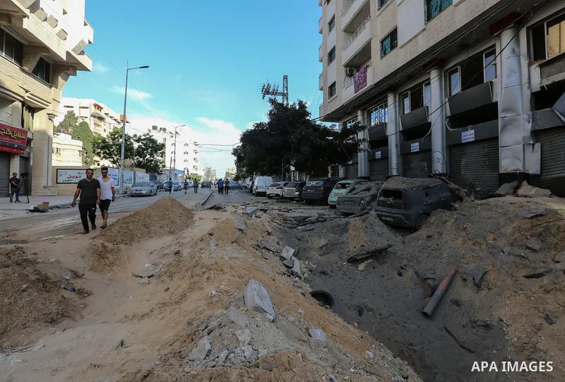 Palestinians search for victims under the rubble of a destroyed building in Gaza City's Rimal residential district following massive Israeli bombardment on the Hamas-controlled enclave on May 16, 2021. Deadly violence er...