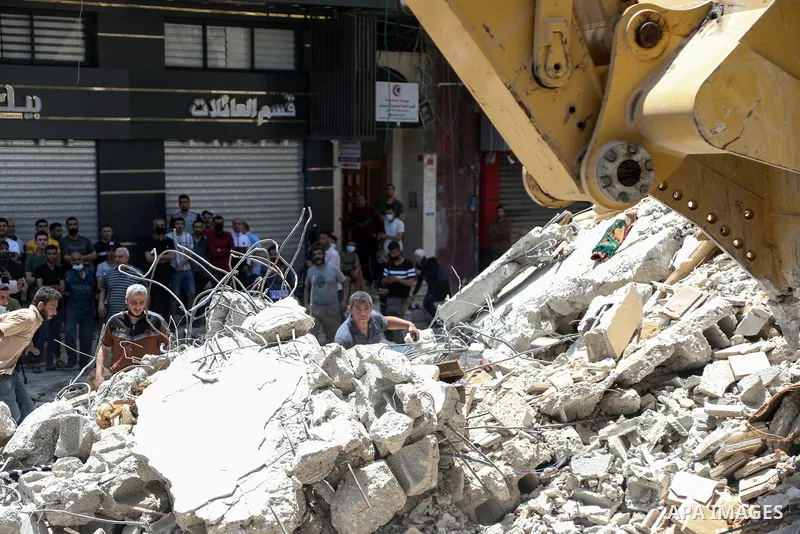 Palestinians search for victims under the rubble of a destroyed building in Gaza City's Rimal residential district following massive Israeli bombardment on the Hamas-controlled enclave on May 16, 2021. Deadly violence er...