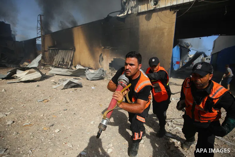 Palestinian firefighters douse a huge fire at the Foamco mattress factory following an Israeli airstrike, east of Jabalia in the northern Gaza Strip on May 17, 2021. Photo by Ashraf Amra