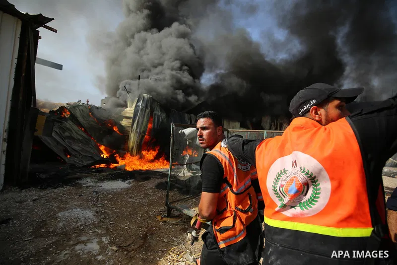 Palestinian firefighters douse a huge fire at the Foamco mattress factory following an Israeli airstrike, east of Jabalia in the northern Gaza Strip on May 17, 2021. Photo by Ashraf Amra