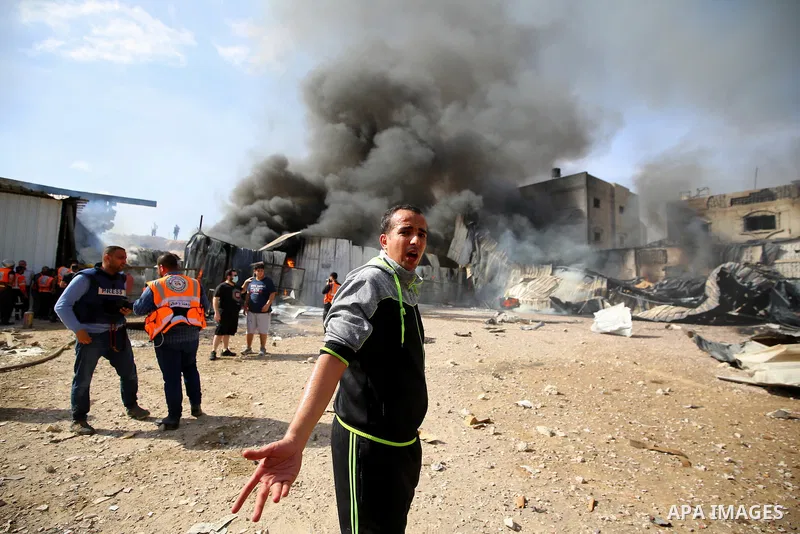 Palestinian firefighters douse a huge fire at the Foamco mattress factory following an Israeli airstrike, east of Jabalia in the northern Gaza Strip on May 17, 2021. Photo by Ashraf Amra