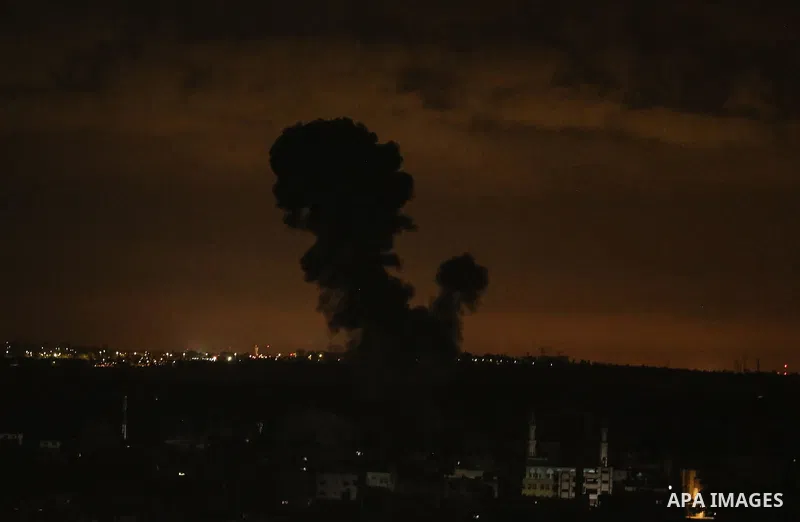 Fire and smoke rise above buildings in the east of Gaza City as Israeli warplanes target the Palestinian enclave, on May 18, 2021. Photo by Bashar Taleb