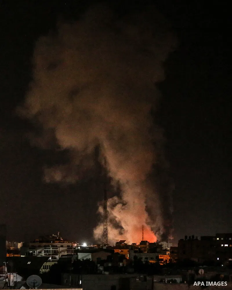 Fire and smoke rise above buildings in Gaza City as Israeli warplanes target the Palestinian enclave, on May 18, 2021. Photo by Bashar Taleb