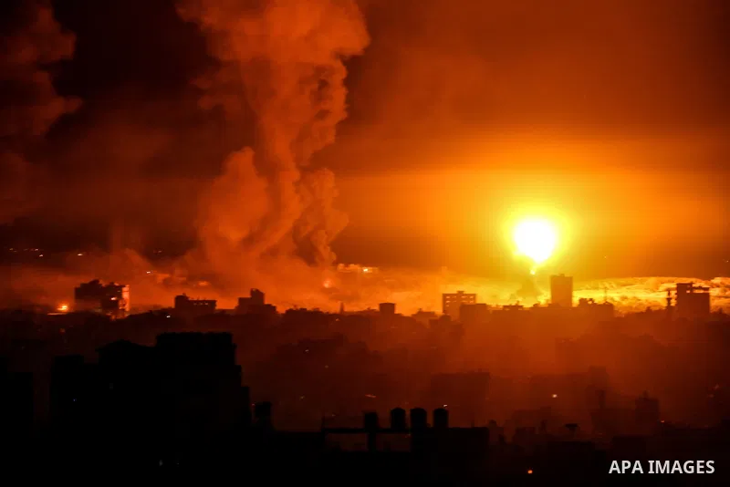 Fire and smoke rise above buildings in Gaza City as Israeli warplanes target the Palestinian enclave, on May 18, 2021. Photo by Bashar Taleb