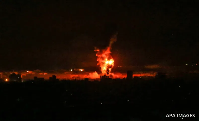 Fire and smoke rise above buildings in Gaza City as Israeli warplanes target the Palestinian enclave, on May 18, 2021. Photo by Bashar Taleb