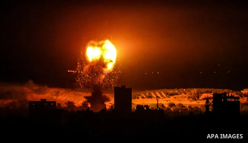 Fire and smoke rise above buildings in Gaza City as Israeli warplanes target the Palestinian enclave, on May 18, 2021. Photo by Bashar Taleb