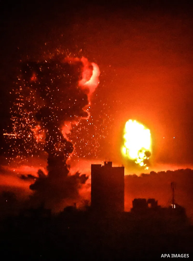 Fire and smoke rise above buildings in Gaza City as Israeli warplanes target the Palestinian enclave, on May 18, 2021. Photo by Bashar Taleb
