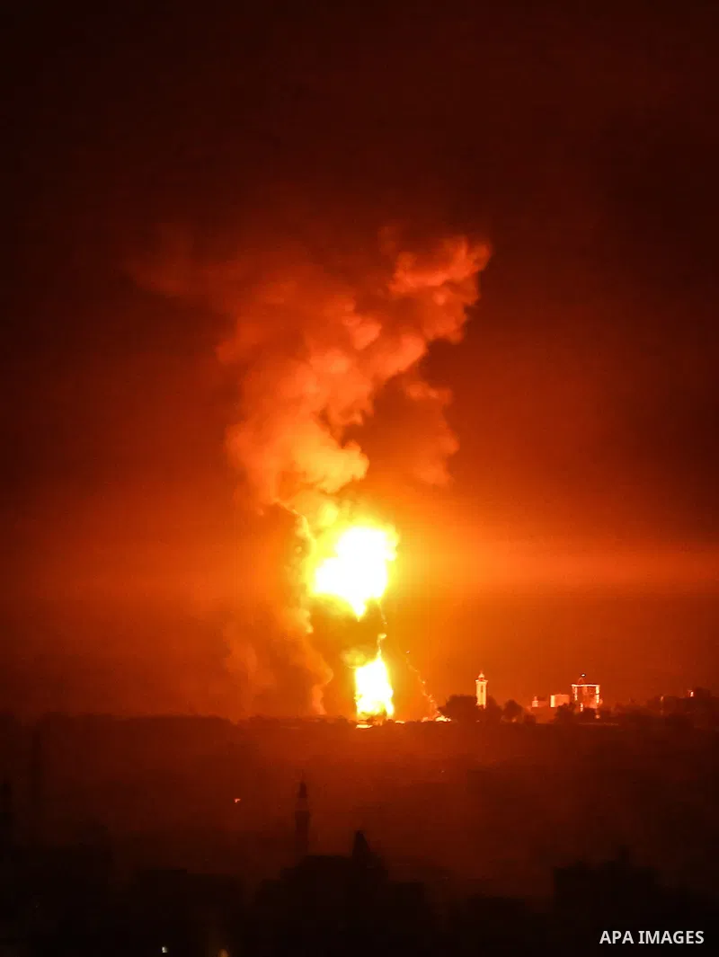 Fire and smoke rise above buildings in Gaza City as Israeli warplanes target the Palestinian enclave, on May 18, 2021. Photo by Bashar Taleb