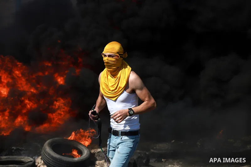Palestinian protesters clash with Israeli soldiers against Israel's occupation and its air campaign on the Gaza strip near the settlement of Beit El and Ramallah in the occupied West Bank on May 18, 2021. Heavy air strik...