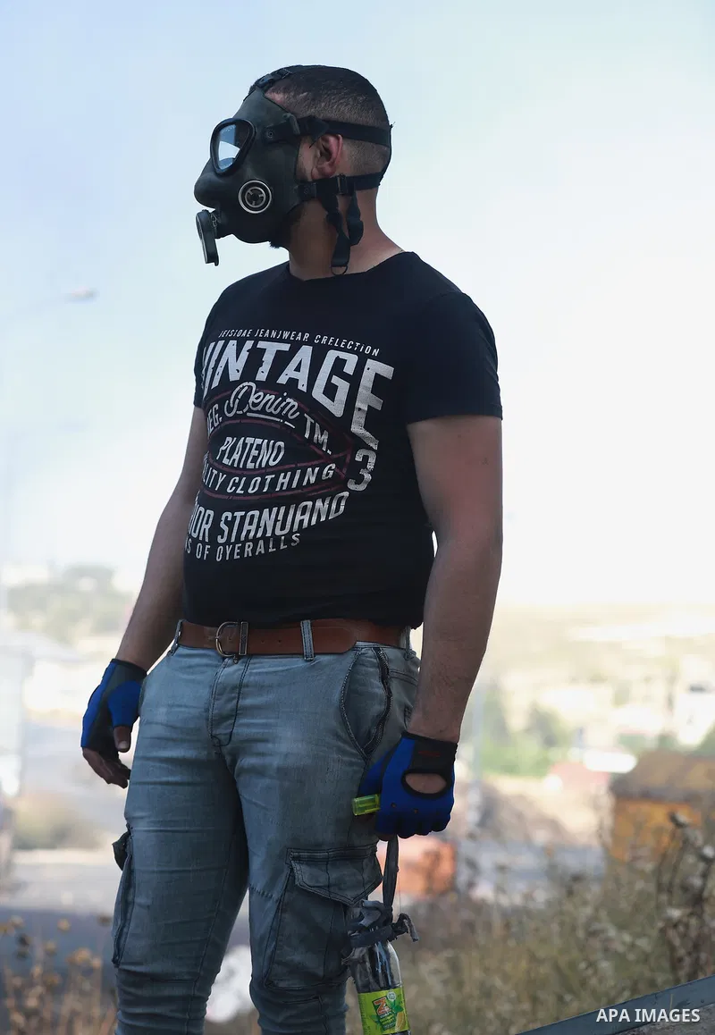 Palestinian protesters clash with Israeli soldiers against Israel's occupation and its air campaign on the Gaza strip near the settlement of Beit El and Ramallah in the occupied West Bank on May 18, 2021. Heavy air strik...