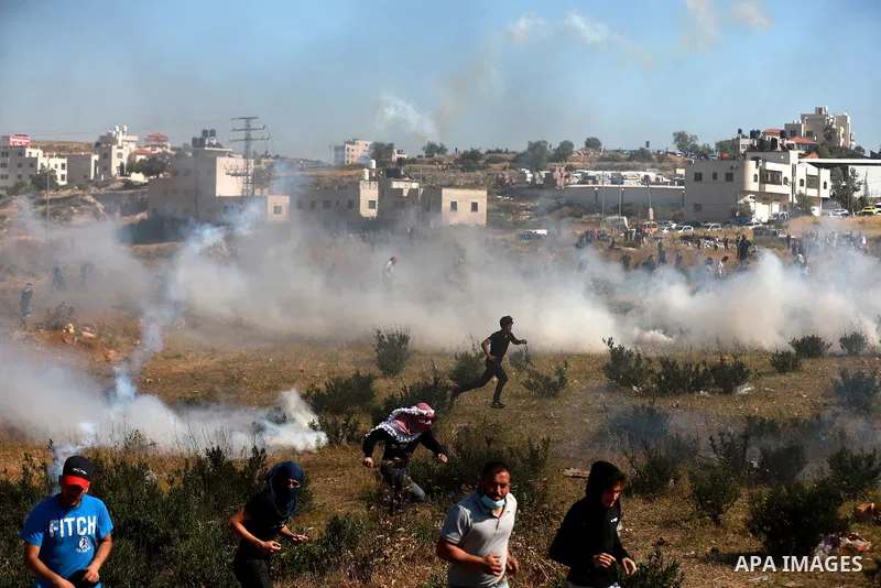 Palestinian protesters clash with Israeli soldiers against Israel's occupation and its air campaign on the Gaza strip near the settlement of Beit El and Ramallah in the occupied West Bank on May 18, 2021. Heavy air strik...