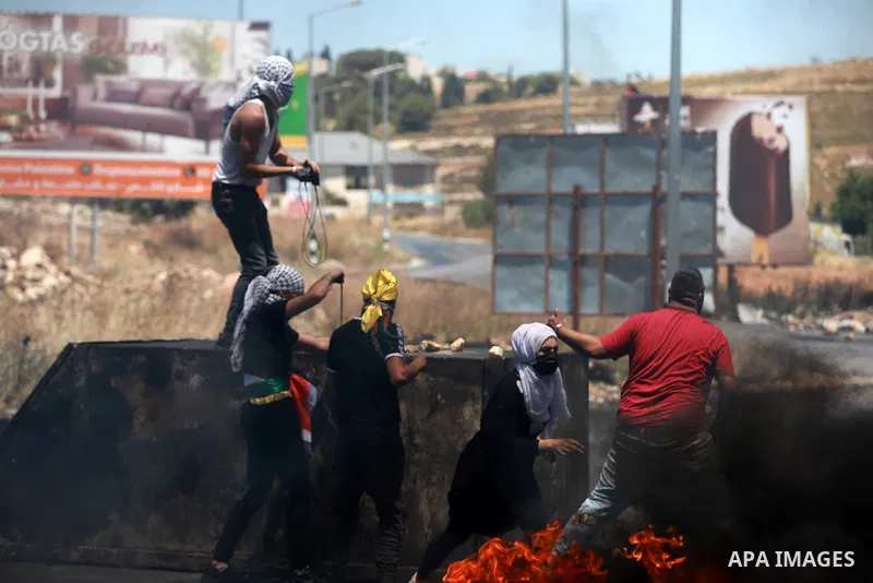 Palestinian protesters clash with Israeli soldiers against Israel's occupation and its air campaign on the Gaza strip near the settlement of Beit El and Ramallah in the occupied West Bank on May 18, 2021. Heavy air strik...