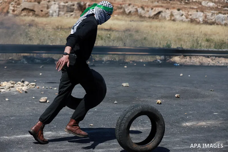 Palestinian protesters clash with Israeli soldiers against Israel's occupation and its air campaign on the Gaza strip near the settlement of Beit El and Ramallah in the occupied West Bank on May 18, 2021. Heavy air strik...
