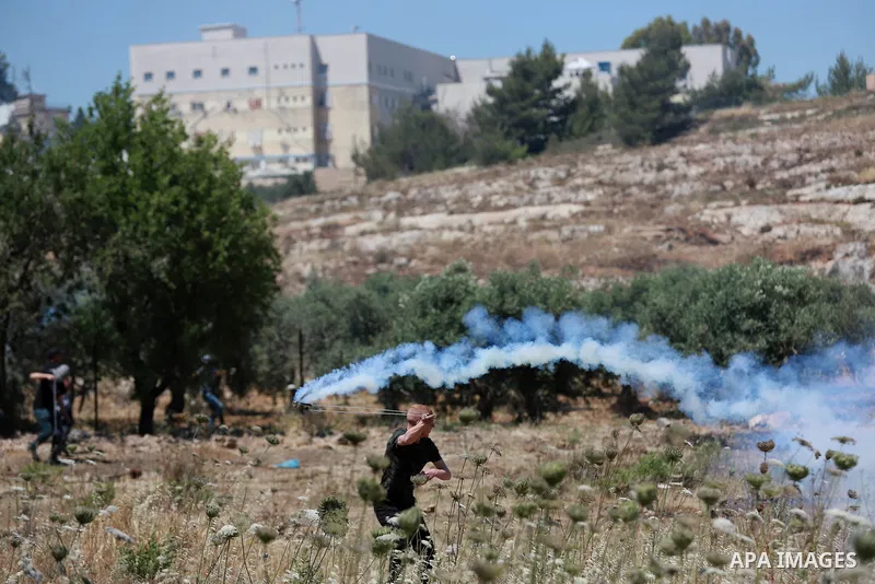 Palestinian protesters clash with Israeli soldiers against Israel's occupation and its air campaign on the Gaza strip near the settlement of Beit El and Ramallah in the occupied West Bank on May 18, 2021. Heavy air strik...