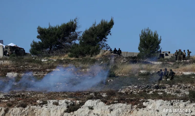 Palestinian protesters clash with Israeli soldiers against Israel's occupation and its air campaign on the Gaza strip near the settlement of Beit El and Ramallah in the occupied West Bank on May 18, 2021. Heavy air strik...