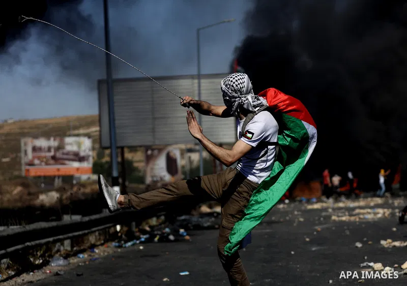 Palestinian protesters clash with Israeli soldiers against Israel's occupation and its air campaign on the Gaza strip near the settlement of Beit El and Ramallah in the occupied West Bank on May 18, 2021. Heavy air strik...