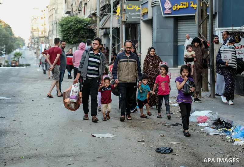 Palestinian families are pictured in a street after evacuating their homes in Gaza city on May 19, 2021, due to heavy shelling by the Israeli military. Photo by Bashar Taleb