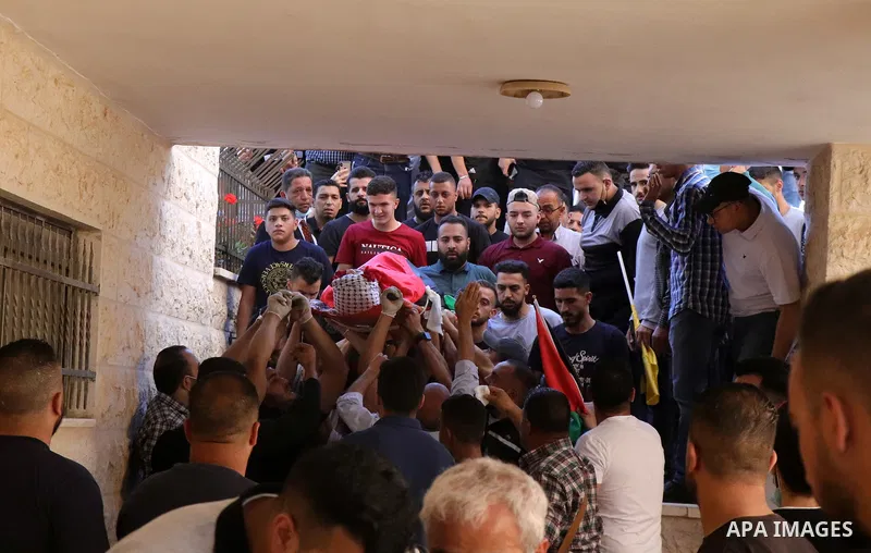 Relatives carry the body of 20-year-old Adham al-Kashef during his funeral in the city of al-Bireh, northeast of Ramallah on May 19, 2021. - The health ministry said four Palestinians were killed in the occupied West Ban...