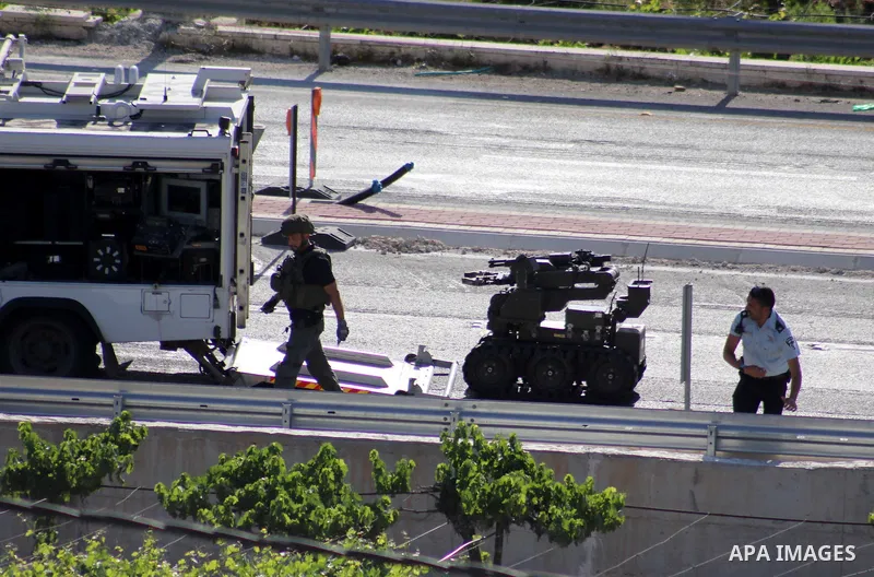 Israeli security forces gather at the scene where troops reportedly ahot and killed a Palestinain woman who they say approached the entrance of the Jewish settlement of Kiryat Arba'a with a gun and fired shots, in the We...