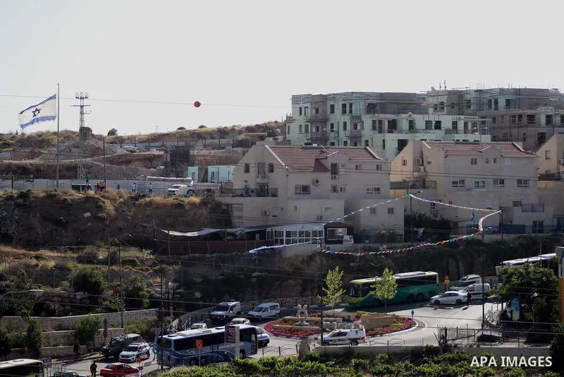 Israeli security forces gather at the scene where troops reportedly ahot and killed a Palestinain woman who they say approached the entrance of the Jewish settlement of Kiryat Arba'a with a gun and fired shots, in the We...