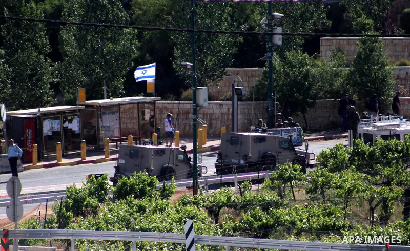 Israeli security forces gather at the scene where troops reportedly ahot and killed a Palestinain woman who they say approached the entrance of the Jewish settlement of Kiryat Arba'a with a gun and fired shots, in the We...
