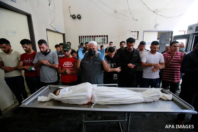 Palestinians pray over the body of Palestinian Diama Assalea, 11, during her funeral following an Israeli air strike amid Israeli-Palestinian fighting, in Jabalia, in the northern Gaza Strip, on May 20, 2021. - Israel an...