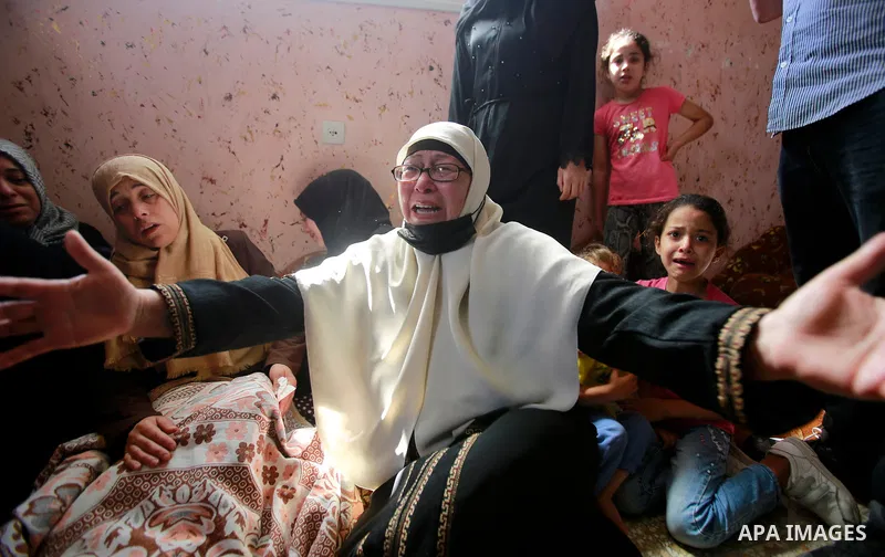 Relatives of Palestinian Diama Assalea, 11, cry during her funeral following an Israeli air strike amid Israeli-Palestinian fighting, in Jabalia, in the northern Gaza Strip, on May 20, 2021. - Israel and the Palestinians...