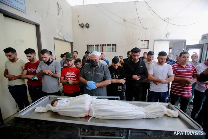 Palestinians pray over the body of Palestinian Diama Assalea, 11, during her funeral following an Israeli air strike amid Israeli-Palestinian fighting, in Jabalia, in the northern Gaza Strip, on May 20, 2021. - Israel an...