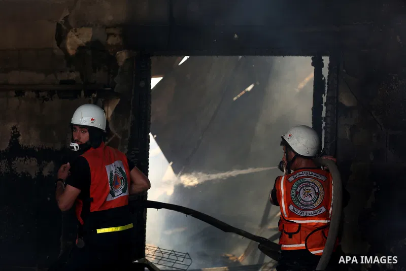 Palestinian firefighters douse a huge fire at the Industrial Area following an Israeli airstrike, east of Gaza City on May 20, 2021. Israel and the Palestinians are mired in their worst conflict in years as Israel pounds...