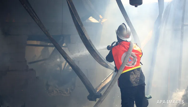 Palestinian firefighters douse a huge fire at the Industrial Area following an Israeli airstrike, east of Gaza City on May 20, 2021. Israel and the Palestinians are mired in their worst conflict in years as Israel pounds...