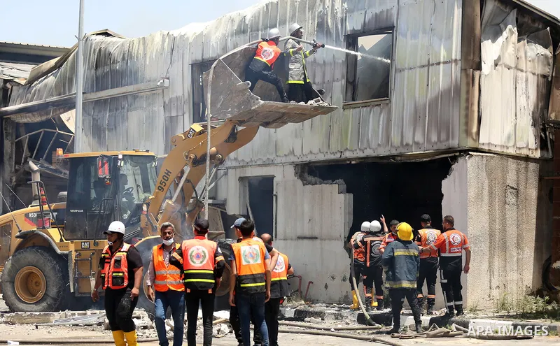 Palestinian firefighters douse a huge fire at the Industrial Area following an Israeli airstrike, east of Gaza City on May 20, 2021. Israel and the Palestinians are mired in their worst conflict in years as Israel pounds...