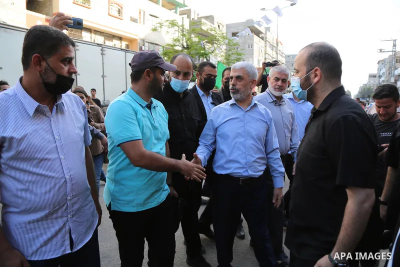 Yahya Sinwar, leader of the Palestinian Hamas movement, is greeted by supporters in Gaza City on May 22, 2021, as he arrives to pay condolences to top Hamas commander Bassem Issa who was killed along others in Israeli ai...