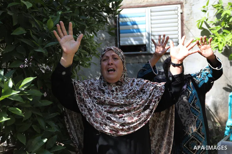 Relatives of Palestinian Mahmoud Abu Jarad, mourn during his funeral in Beit Hanun in the northern Gaza Strip on May 24, 2021, after he died from wounds sustained during the latest conflict with Israel. Photo by Ashraf A...
