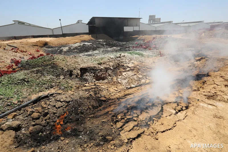 A Palestinian worker salvages items from the damaged Coca Cola factory in Gaza's industrial area, on May 25, 2021, which was hit by Israeli strikes prior to a cease-fire ending 11 days of deadly violence between Israel a...