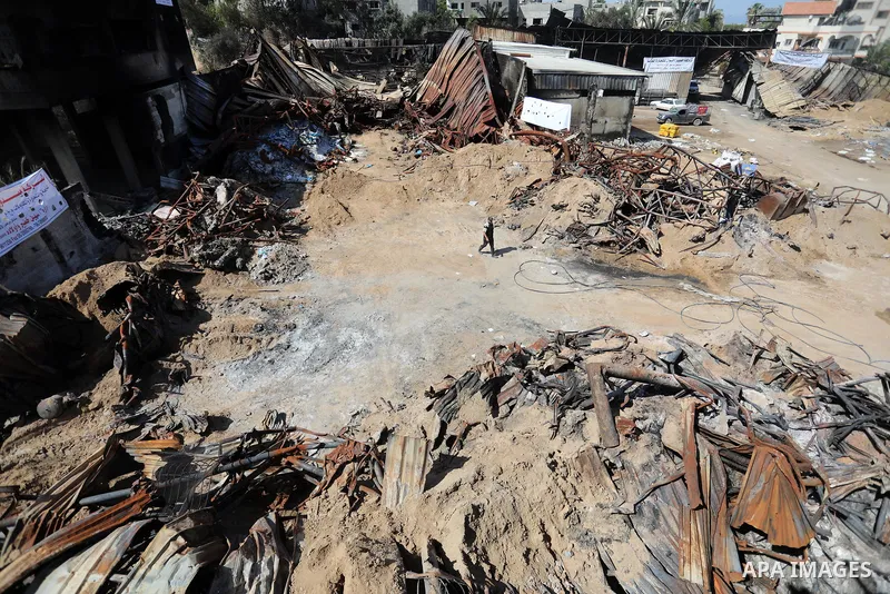 A Palestinian checks the destruction at an agricultural fertilisers factory targeted in recent Israeli air strikes, in Beit Lahia, in the northern of Gaza Strip on May 26, 2021. A ceasefire was reached late last week aft...