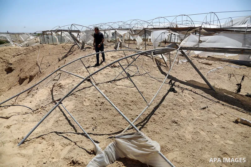 A Palestinian checks the destruction at an agricultural fertilisers factory targeted in recent Israeli air strikes, in Beit Lahia, in the northern of Gaza Strip on May 26, 2021. A ceasefire was reached late last week aft...