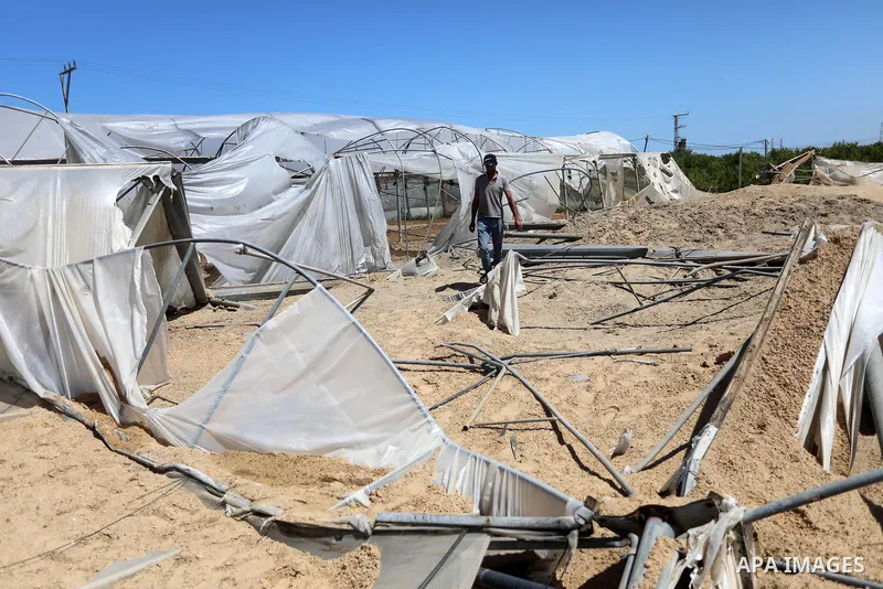A Palestinian checks the destruction at an agricultural fertilisers factory targeted in recent Israeli air strikes, in Beit Lahia, in the northern of Gaza Strip on May 26, 2021. A ceasefire was reached late last week aft...