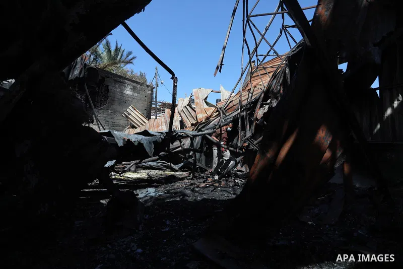 A Palestinian checks the destruction at an agricultural fertilisers factory targeted in recent Israeli air strikes, in Beit Lahia, in the northern of Gaza Strip on May 26, 2021. A ceasefire was reached late last week aft...