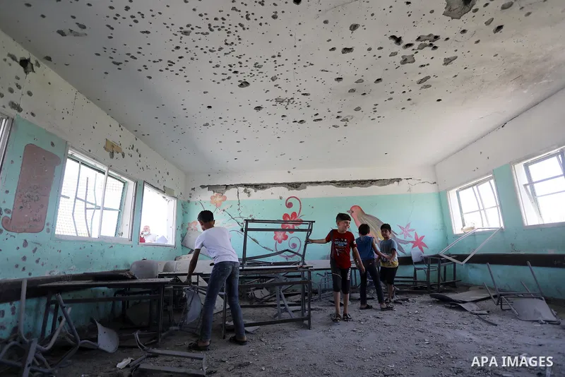 Palestinians check items in a classroom at a school hit during Israeli shelling at the Zeitun neighbourhood in Gaza City, on May 27, 2021. - A ceasefire was reached late last week after 11 days of deadly violence between...
