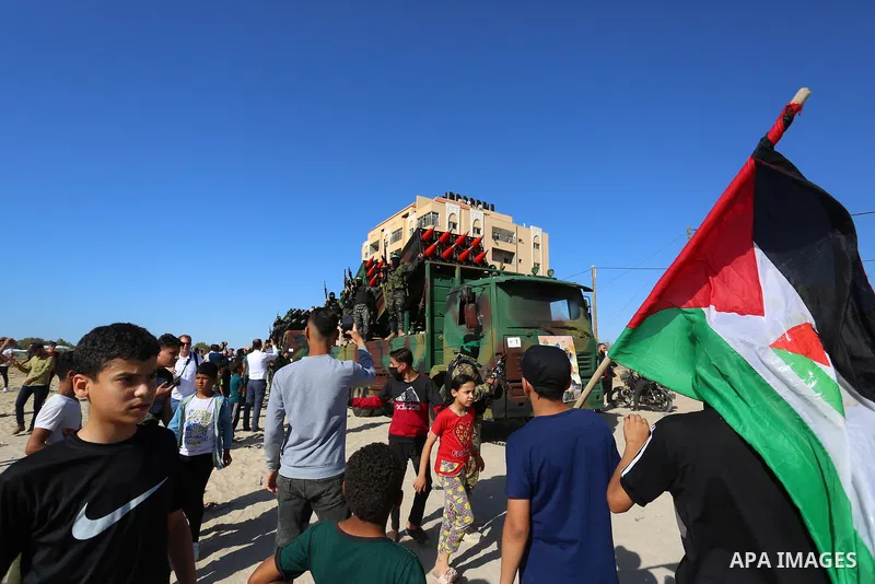 Members of the Izz-Al Din Al-Qassam Brigades, the armed wing of the Hamas movement, parade in an anti-Israel rally in Khan Younis, in the southern Gaza Strip on May 27, 2021. - The Egyptian-brokered truce ended 11 days o...