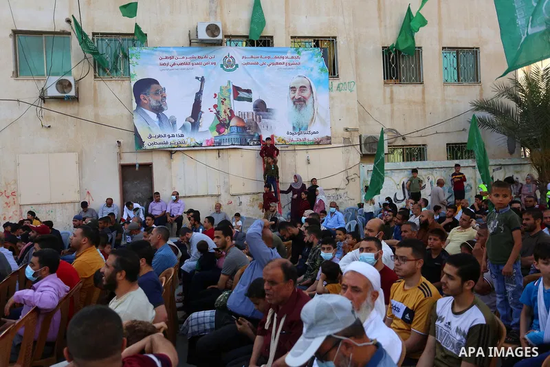 Palestinian supporters of the Ezz-Al Din Al-Qassam Brigades, the armed wing of the Palestinian Hamas movement parade in an anti-Israel rally Al-Bureij refugee camp in the central Gaza Strip on May 28, 2021. - The Egyptia...