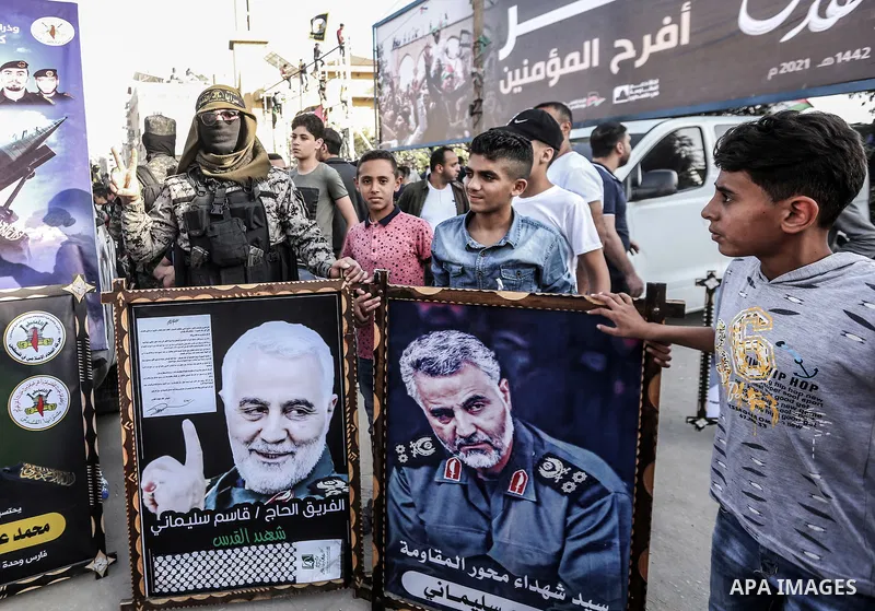 Supporters of al-Quds Brigades, the armed wing of the Palestinian Islamic Jihad movement, gather to watch them parade in the streets of Gaza City on May 29, 2021, more than a week after a ceasefire brought an end to 11 d...