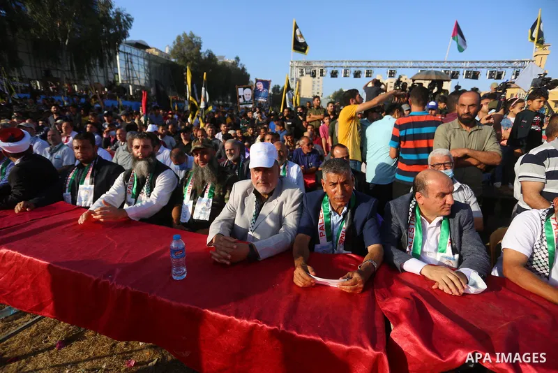 Supporters of al-Quds Brigades, the armed wing of the Palestinian Islamic Jihad movement, gather to watch them parade in the streets of Gaza City on May 29, 2021, more than a week after a ceasefire brought an end to 11 d...