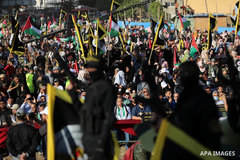 Supporters of al-Quds Brigades, the armed wing of the Palestinian Islamic Jihad movement, gather to watch them parade in the streets of Gaza City on May 29, 2021, more than a week after a ceasefire brought an end to 11 d...