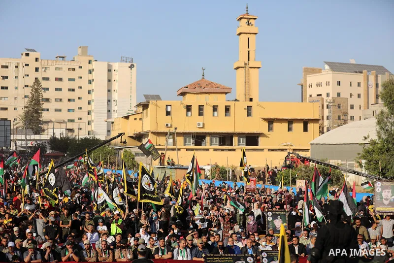 Supporters of al-Quds Brigades, the armed wing of the Palestinian Islamic Jihad movement, gather to watch them parade in the streets of Gaza City on May 29, 2021, more than a week after a ceasefire brought an end to 11 d...
