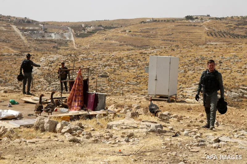 Evicted Palestinian residents pack their belongings during an Israeli demolition of Palestinian homes located within the "Area C" of the occupied West Bank, where Israel retains full control over planning and constructio...