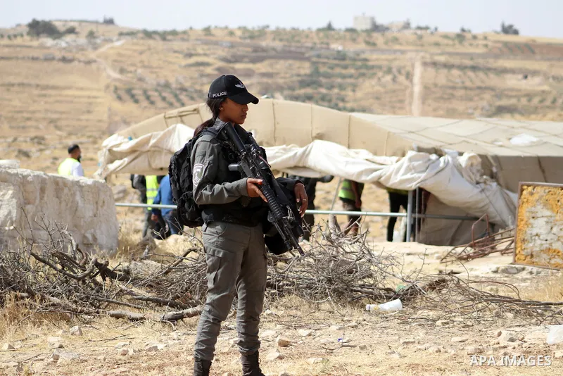 Evicted Palestinian residents pack their belongings during an Israeli demolition of Palestinian homes located within the "Area C" of the occupied West Bank, where Israel retains full control over planning and constructio...